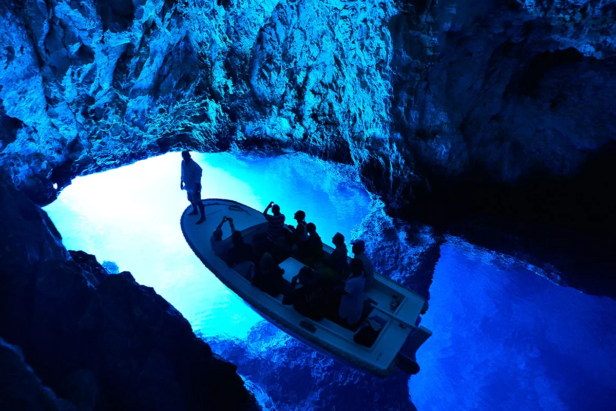 The Blue cave on the island of Biševo and a boat full of excursionists