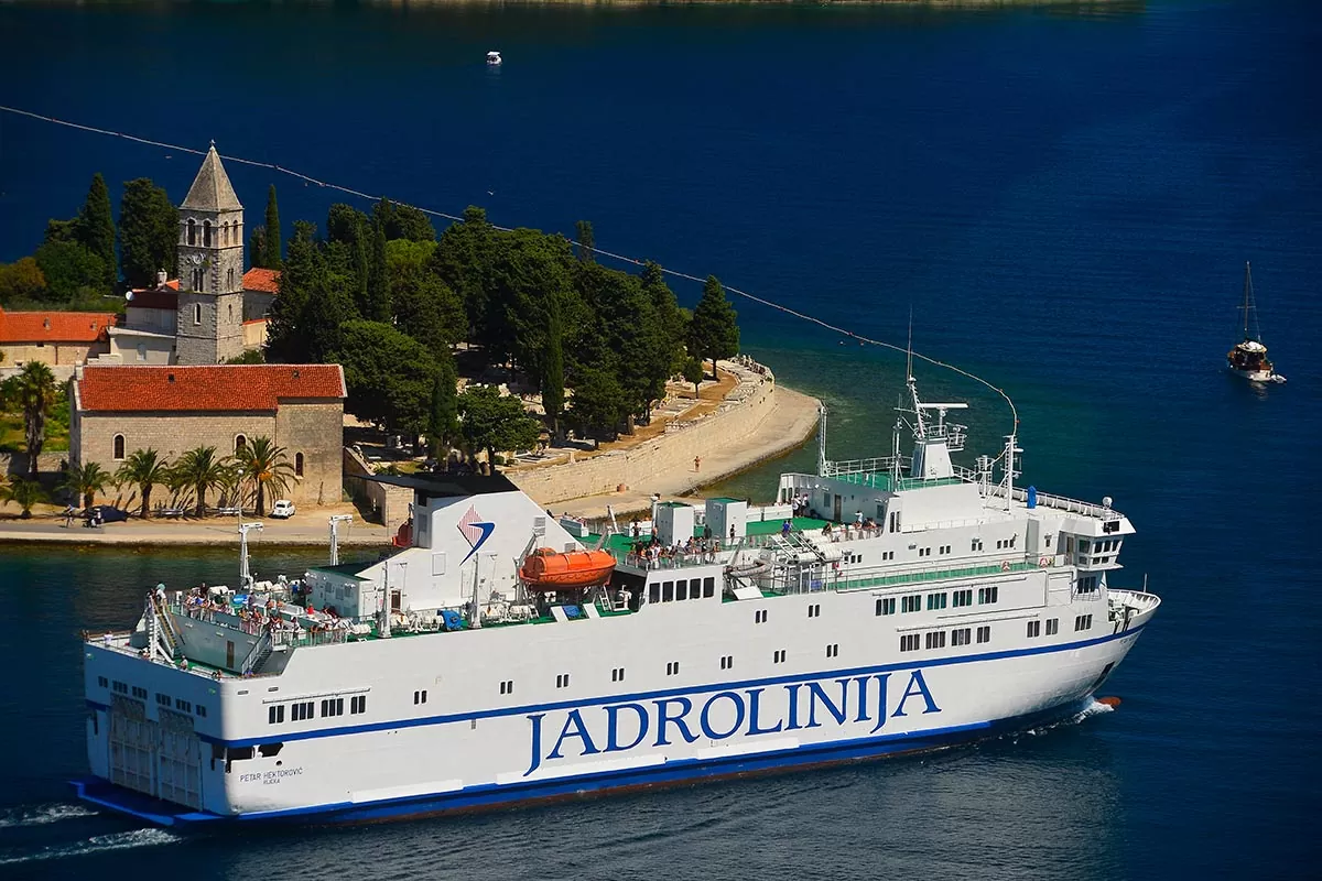 The Jadrolinija ferry from Split to Vis passing in front of the Franciscan monastery on the Prirovo peninsula